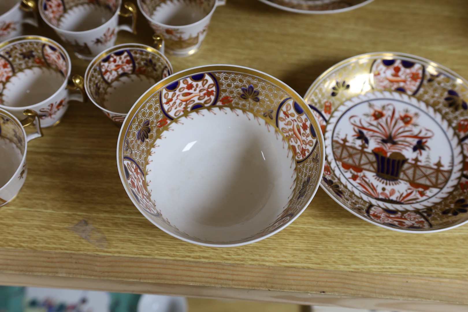 A Spode part Imari tea service consisting of six London shape tea cups, coffee cups and saucers, two graduated saucer dishes and a bowl pattern 1495